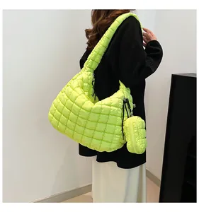 Detailed shot of fluorescent green quilted cloud bag featuring padded texture and mini pouch