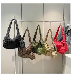 Row of quilted cloud bags in black brown khaki green and red with matching mini pouches