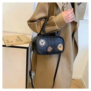 Close-up of black retro Boston bag with vintage eagle and number embroidery patches