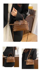 Detail of retro brown shell bag with shiny leather, dual zippers and a top handle