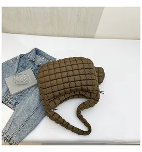 Detail of dark brown quilted bubble bag showing soft puffy texture and hobo style