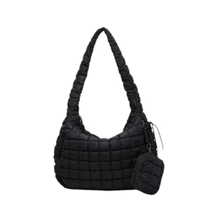 Quilted cloud shoulder bag in black nylon with puffy square stitching and matching mini coin pouch