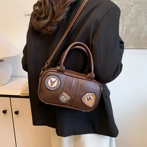 Brown vintage faux leather shoulder bag with American style embroidery patches and top handle