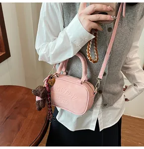 Pink bowling bag detail with MAUDAI BEAR embossing and cute plush bear charm accessory