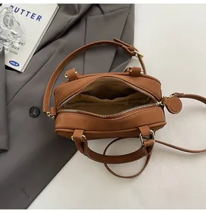 Detail view of tan bowling bag interior with zipper pockets and adjustable straps