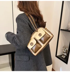 Close-up of vintage multi-pocket shoulder bag in glossy brown and beige leather