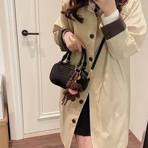 Fashionable black bowling handbag with LAUDAR embossing and cute brown bear charm