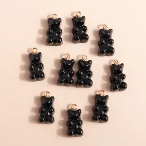 Top view of 10 shiny black resin bear charms with gold loops for DIY jewelry making