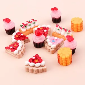 Close-up of miniature resin cakes and pizza food models for DIY crafts and phone case decor