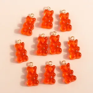 Group of 10 orange translucent resin gummy bear charms with golden metal loops