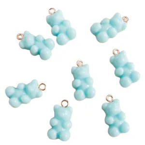 Set of 8 light blue gummy bear resin charms with silver rings on a clean white background