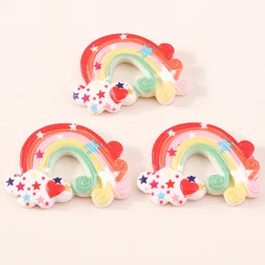 Detailed view of three resin rainbow cloud pendants with stars and hearts for DIY crafts