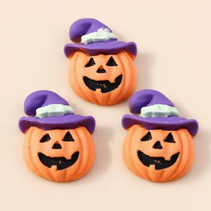 Set of three Halloween pumpkin resin charms with purple witch hats for DIY crafts