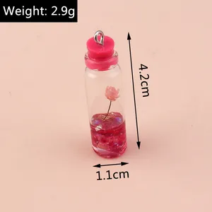 Detail showing dimensions of mini glass bottle pendant with pink dried flower and liquid