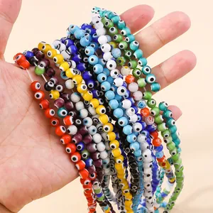 Colorful resin evil eye beads held in hand for DIY necklace and bracelet jewelry making