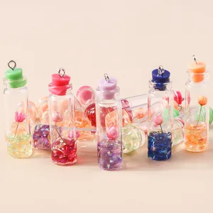 Miniature glass jars with dried flowers and colorful stoppers for DIY jewelry making