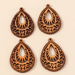 Set of 4 hollow drop-shaped wooden charms with geometric laser cut bohemian patterns