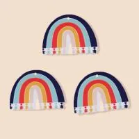 Close-up of three colorful acrylic rainbow pendants with pre-drilled holes for DIY jewelry