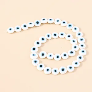 Colorful 10mm resin evil eye beads arranged in a spiral for DIY jewelry making