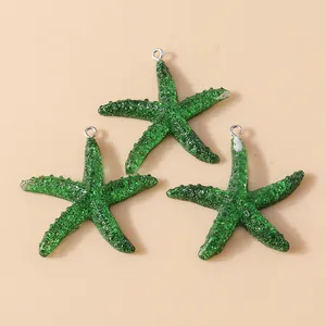 Three green sparkling resin starfish charms with silver rings for DIY jewelry making