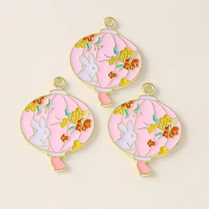 Detail of pink enamel bunny lantern charms in gold-tone alloy for DIY jewelry