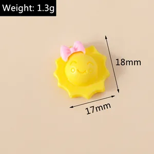 Detailed view of yellow sun resin charm with pink bow, measuring 18mm by 17mm and 1.3g
