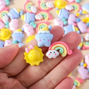Hand holding macaron resin cartoon stars and rainbow cloud DIY charm accessories