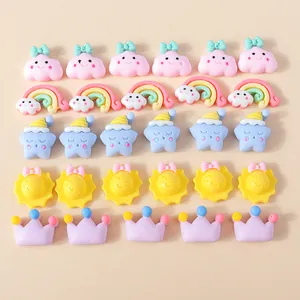 Flat lay of colorful resin rainbow cloud and star charms for DIY phone case crafts