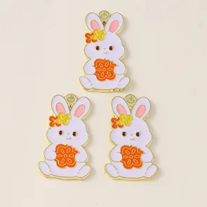 Detailed view of three enamel rabbit charms with colorful flowers and gold plating
