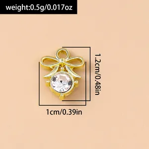 Macro shot of gold bow pendant with pearl and zircon showing dimensions 1.2cm x 1cm