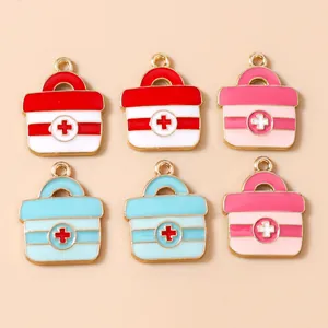 Flat lay of colorful enamel first aid kit pendants for DIY jewelry and accessory making