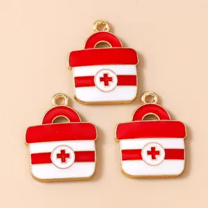 Set of three alloy first aid kit charms in red and white enamel with gold metal finish