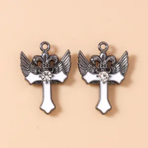 Makroaufnahme von gotischen Kreuz-Flügel-Anhängern mit Strasssteinen und weißem Emaille
