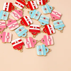 Flat lay of colorful enamel medical box charms with metal loops for DIY jewelry making