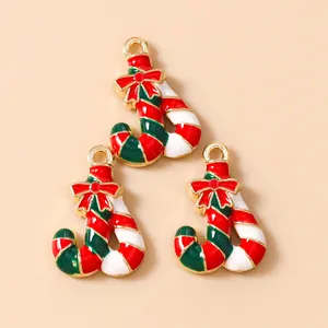 Three enamel Christmas candy cane charms with red bows for DIY jewelry making and pendants