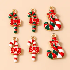 Close-up of enamel candy cane charms with red bows for DIY Christmas jewelry making