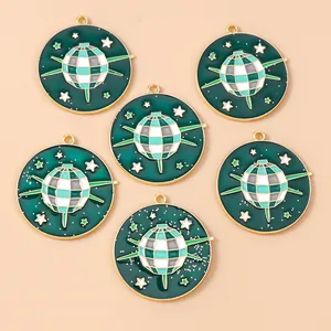 Detailed view of six green enamel disco ball pendants with gold stars for DIY jewelry