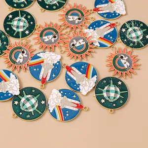 Close-up of enamel space travel shuttle, astronaut, and disco ball charms for DIY jewelry