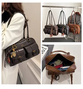 Detail view of retro shoulder bag featuring double buckle pockets and tennis racket charm