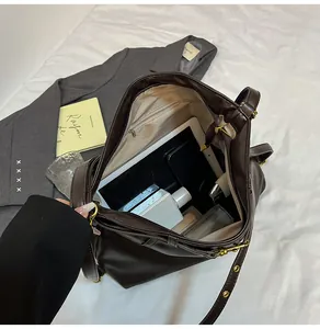 Top view of large brown tote bag interior showing spacious compartments for gadgets