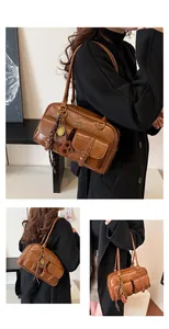 Detail view of brown vintage Boston bag showing multiple utility pockets and texture