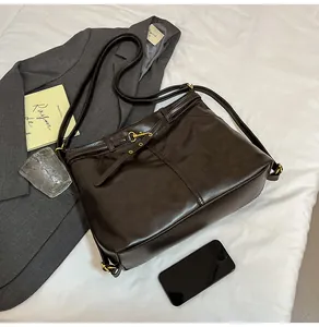 Detail view of vintage dark brown tote bag with gold hardware and metal corners