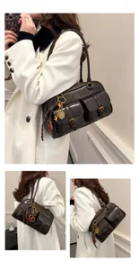 Detail view of brown vintage Boston bag featuring double front pockets and gold hardware