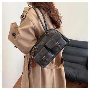 Detail of vintage Maillard brown shoulder bag with double pockets and metallic accents