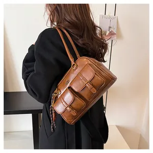 Detailed macro view of vintage brown leather texture and decorative front buckled pockets