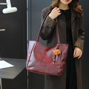Borsa tote vintage bordeaux in pelle testurizzata con ciondolo a forma di cagnolino