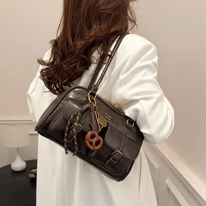 Retro brown Boston shoulder bag with multi-pocket design and decorative charms for women