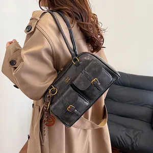 Vintage black Boston bag in textured PU leather with front buckle pockets and top handles