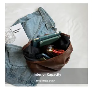 Spacious brown leather tote bag interior showing capacity for tablets and essentials