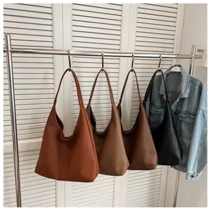 Detail view of large capacity hobo bags in four colors displayed on metal hangers